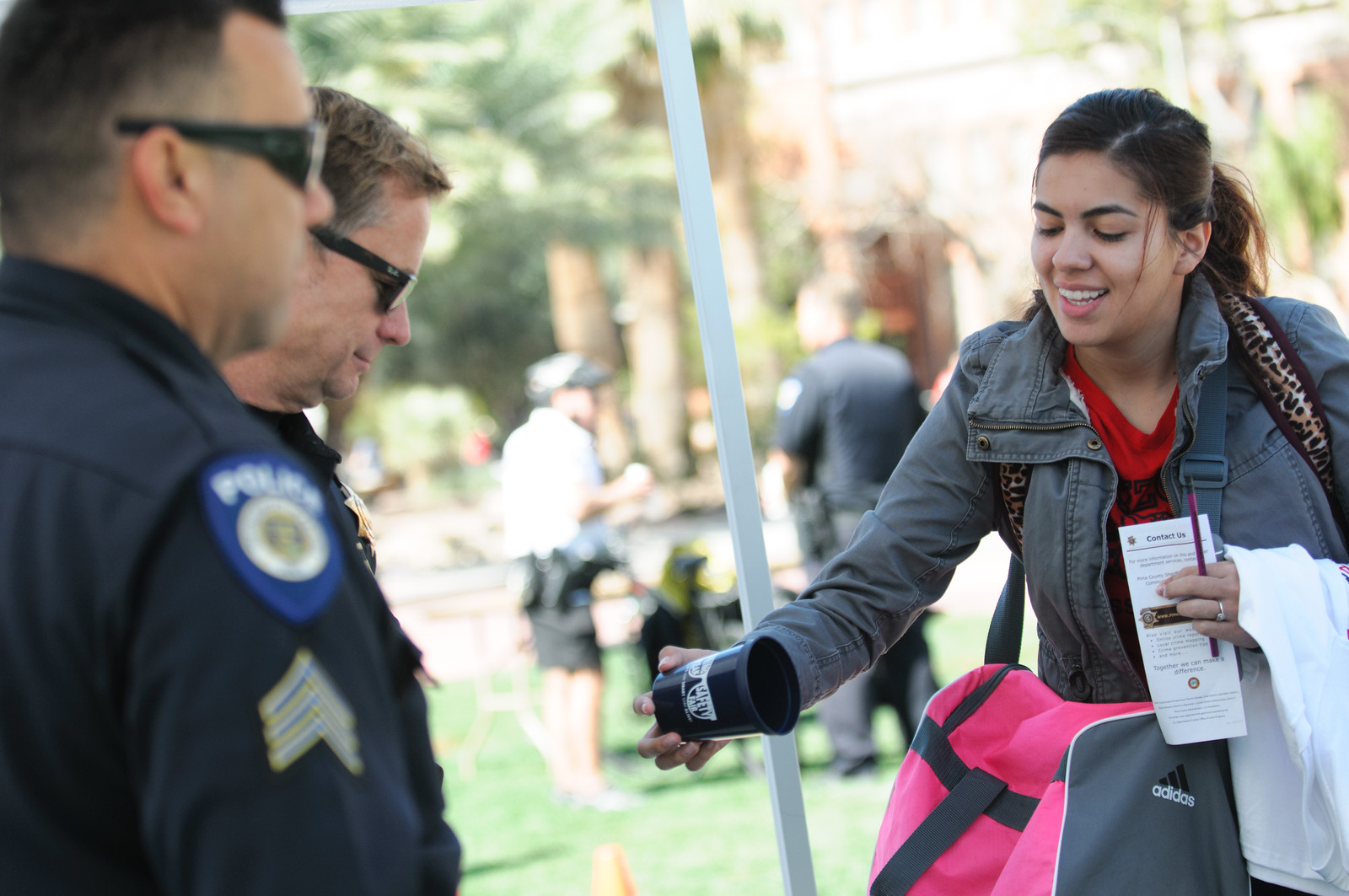 Student with police officers at event on UA Mall