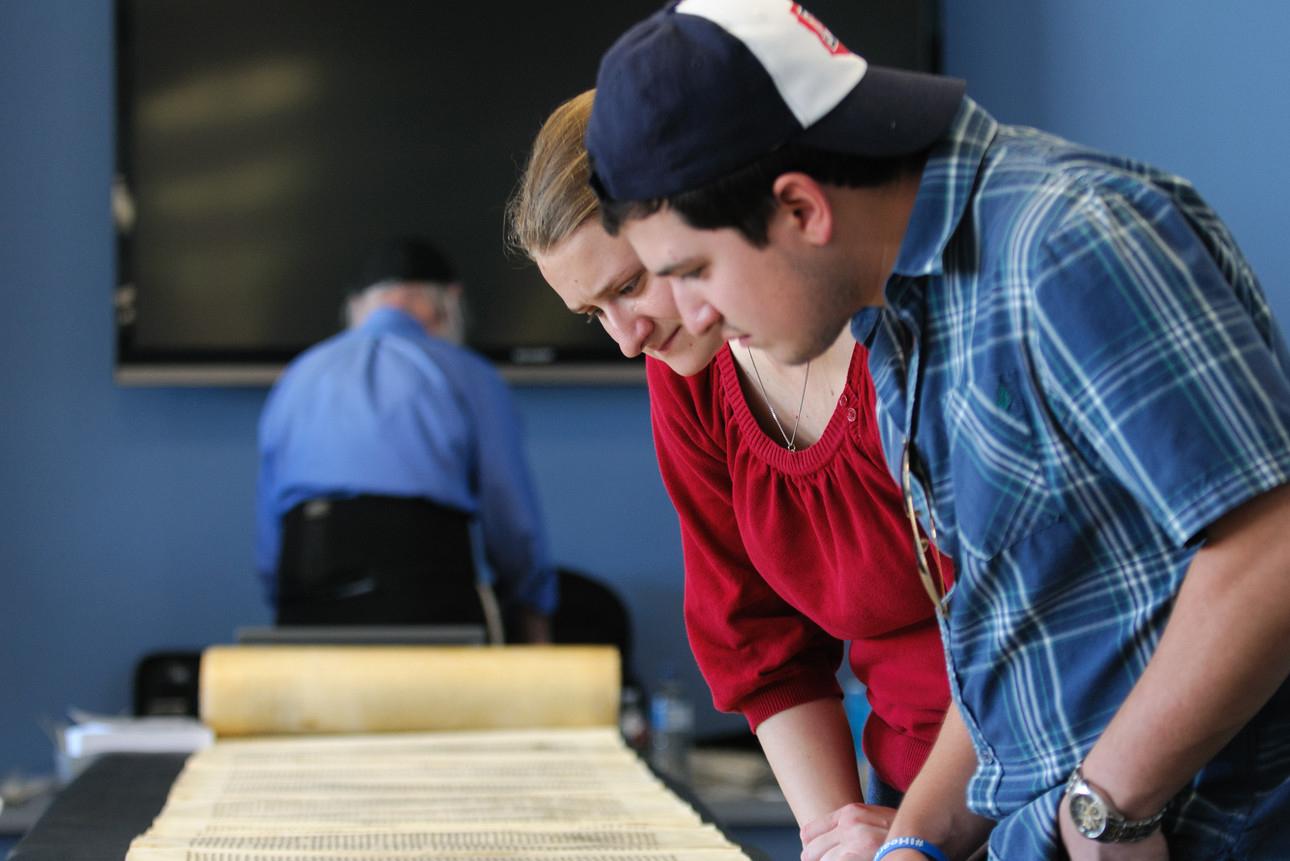 Two students looking at ancient scroll