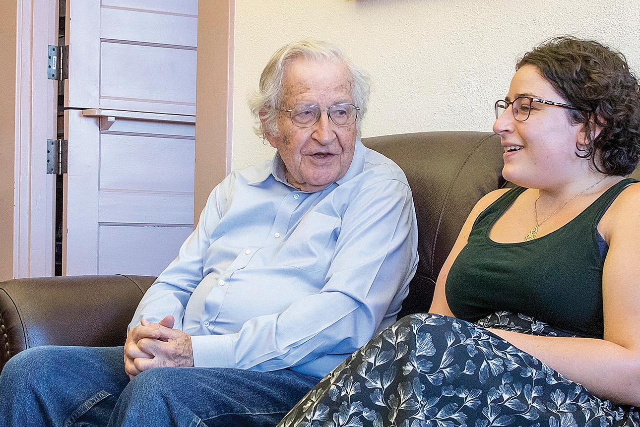 Student sitting with UA Professor Noam Chomsky