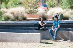 Two students talking outdoors on campus